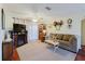 Inviting living room with a plush sofa, entertainment center with fireplace, and a ceiling fan for added comfort at 1172 Chelsea Ln, Holiday, FL 34691