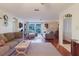 Bright living room with hardwood floors, comfortable seating, and large sliding glass doors for natural light at 1172 Chelsea Ln, Holiday, FL 34691