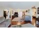 Spacious living room with hardwood floors, fireplace, ceiling fan, and an open layout at 1172 Chelsea Ln, Holiday, FL 34691