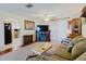 A cozy living room with hardwood floors, a fireplace, and a view of the kitchen at 1172 Chelsea Ln, Holiday, FL 34691