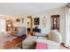 Inviting living room with hardwood floors, a comfortable armchair, and a glimpse of the bedroom at 1172 Chelsea Ln, Holiday, FL 34691