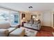 Comfortable living room featuring hardwood floors, a cozy sofa, and access to the outdoor patio at 1172 Chelsea Ln, Holiday, FL 34691
