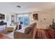 Comfortable living room featuring hardwood floors, natural light, and a view of the outdoor patio at 1172 Chelsea Ln, Holiday, FL 34691