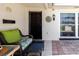 Cozy outdoor patio featuring wicker furniture, decorative elements, and tiled flooring, offering a pleasant space at 1172 Chelsea Ln, Holiday, FL 34691