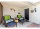 Relaxing outdoor patio with wicker furniture, decorative wall art and tiled flooring providing a cozy retreat at 1172 Chelsea Ln, Holiday, FL 34691