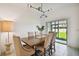Dining room featuring a wooden table, upholstered chairs, and sliding glass doors leading to the backyard at 21811 Lyonia Ln, Land O Lakes, FL 34637