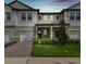 Charming townhome featuring a well-maintained lawn, brick driveway, and an inviting covered front porch at 21811 Lyonia Ln, Land O Lakes, FL 34637