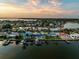 Wide aerial view of waterfront homes and canal at sunset at 7850 2 S Ave, St Petersburg, FL 33707