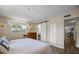 Main bedroom with king bed and barn door to en suite bath at 7850 2 S Ave, St Petersburg, FL 33707