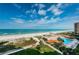 Stunning aerial view of beach, pool, and building at 880 Mandalay Ave # C713, Clearwater Beach, FL 33767
