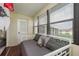 Bright sunroom features a daybed and large windows at 5245 Amulet Dr # 306, New Port Richey, FL 34652