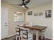 Bright dining area with wooden table and four chairs, offering a casual and comfortable space at 5245 Amulet Dr # 306, New Port Richey, FL 34652