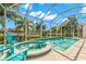 Relaxing pool and spa area with turquoise water and screened enclosure at 709 Manns Harbor Dr, Apollo Beach, FL 33572