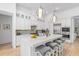Gourmet kitchen boasting white cabinets, a sizable island, and beautiful light fixtures at 709 Manns Harbor Dr, Apollo Beach, FL 33572