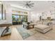Open concept living space with hardwood floors, a large sectional sofa, and views to the kitchen and pool at 709 Manns Harbor Dr, Apollo Beach, FL 33572