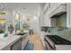 Modern kitchen with stainless steel appliances, a large island, and a stunning backsplash at 709 Manns Harbor Dr, Apollo Beach, FL 33572