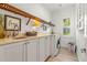 Laundry room with built-in shelving and a sink at 709 Manns Harbor Dr, Apollo Beach, FL 33572