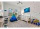 bedroom with crib, teepee, and playful decor at 709 Manns Harbor Dr, Apollo Beach, FL 33572