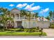 Two-story home with light-colored siding, a metal roof, and a covered porch at 709 Manns Harbor Dr, Apollo Beach, FL 33572