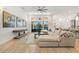 Bright living room with large sectional sofa, hardwood floors, and access to a lanai at 709 Manns Harbor Dr, Apollo Beach, FL 33572