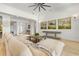 Open living area showcasing hardwood floors, a comfy sectional sofa, and an inviting entryway at 709 Manns Harbor Dr, Apollo Beach, FL 33572