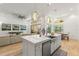 Open kitchen with white cabinets, large island, and views to the living and dining areas at 709 Manns Harbor Dr, Apollo Beach, FL 33572