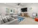 Bright living room with sectional sofa and large TV at 709 Manns Harbor Dr, Apollo Beach, FL 33572
