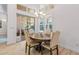 Charming dining area with wooden table and chairs near the kitchen and pool access at 709 Manns Harbor Dr, Apollo Beach, FL 33572