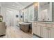 Luxurious bathroom with double vanities, soaking tub, and walk-in shower at 709 Manns Harbor Dr, Apollo Beach, FL 33572