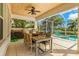 Outdoor kitchen with built-in grill, dining area, and pool view at 709 Manns Harbor Dr, Apollo Beach, FL 33572