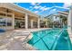 Resort-style pool with covered patio and outdoor kitchen at 709 Manns Harbor Dr, Apollo Beach, FL 33572