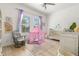 Bedroom featuring a crib, rocker, and play tent at 709 Manns Harbor Dr, Apollo Beach, FL 33572