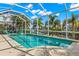 Relaxing pool and spa with screened enclosure and water view at 709 Manns Harbor Dr, Apollo Beach, FL 33572