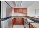 Modern kitchen with stainless steel appliances and granite countertops at 880 Mandalay Ave # C713, Clearwater Beach, FL 33767