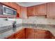 Kitchen with granite countertops and wood cabinets at 880 Mandalay Ave # C713, Clearwater Beach, FL 33767