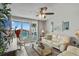 Living room with water view, comfy seating, and balcony access at 5701 Bahia Del Mar Cir # 507, St Petersburg, FL 33715