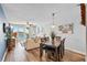Bright dining area with wood flooring and view to balcony and water at 5701 Bahia Del Mar Cir # 507, St Petersburg, FL 33715