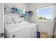 Convenient laundry room with Whirlpool washer and dryer, and ample shelving at 5701 Bahia Del Mar Cir # 507, St Petersburg, FL 33715