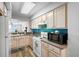 Kitchen with white cabinets and teal backsplash at 5701 Bahia Del Mar Cir # 507, St Petersburg, FL 33715