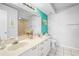Bathroom with double vanity and teal accent wall at 5701 Bahia Del Mar Cir # 507, St Petersburg, FL 33715