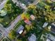 Aerial view of a single-Gathering home nestled among lush trees in a quiet neighborhood at 55 W Lemon St, Tarpon Springs, FL 34689