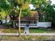 House exterior featuring a porch, landscaping, and white fence at 55 W Lemon St, Tarpon Springs, FL 34689