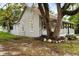 House exterior showcasing side yard and mature tree at 55 W Lemon St, Tarpon Springs, FL 34689