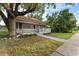 Renovated bungalow with a large tree in the front yard at 55 W Lemon St, Tarpon Springs, FL 34689