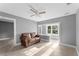 Living room featuring a brown couch and large window at 55 W Lemon St, Tarpon Springs, FL 34689