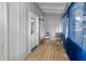 Cozy screened porch with wood floors and two chairs at 55 W Lemon St, Tarpon Springs, FL 34689