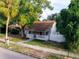 Charming house with front porch, landscaping, and white picket fence at 55 W Lemon St, Tarpon Springs, FL 34689