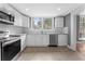 Kitchen features white cabinets, granite counters, and stainless steel appliances at 55 W Lemon St, Tarpon Springs, FL 34689