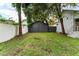 Backyard with detached garage and grassy area at 55 W Lemon St, Tarpon Springs, FL 34689