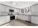 Updated kitchen, white cabinets, stainless steel appliances, granite countertops at 55 W Lemon St, Tarpon Springs, FL 34689